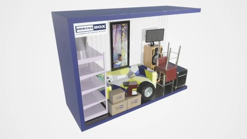 Intérieur d'un box de stockage Hontas Box 14m² avec lits, table, chaises, lave- linge et cartons prêts à stocker pendant des travaux en Gironde
